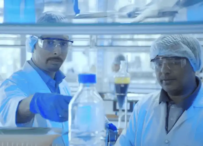 Scientists in a Synthite laboratory conducting natural extract research.